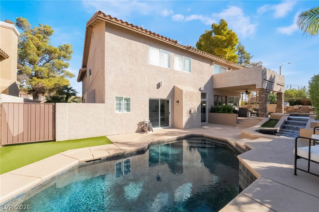 826 Rising Star Drive, Henderson, NV 89014 An inviting backyard pool accents the exterior of this two-story stucco residence.