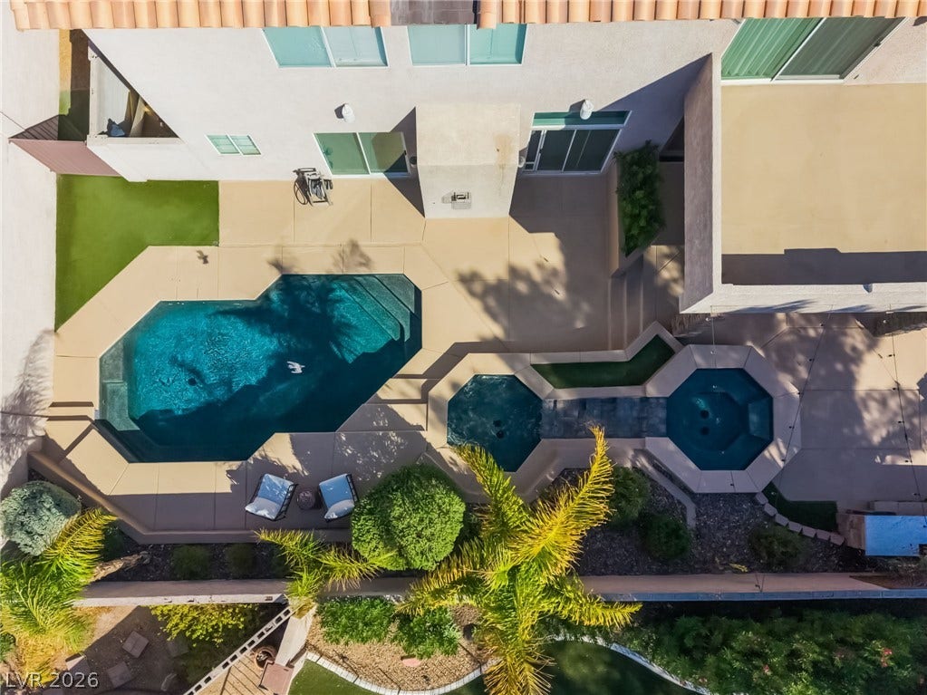 826 Rising Star Drive, Henderson, NV 89014 An overhead view reveals a geometric swimming pool, spa, and expansive patio surround.