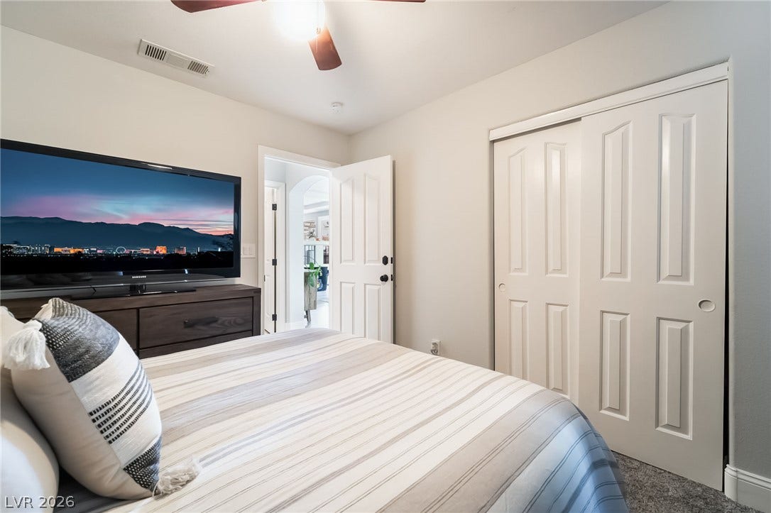 826 Rising Star Drive, Henderson, NV 89014 Smooth plaster walls and soft carpeting frame this restful bedroom space.
