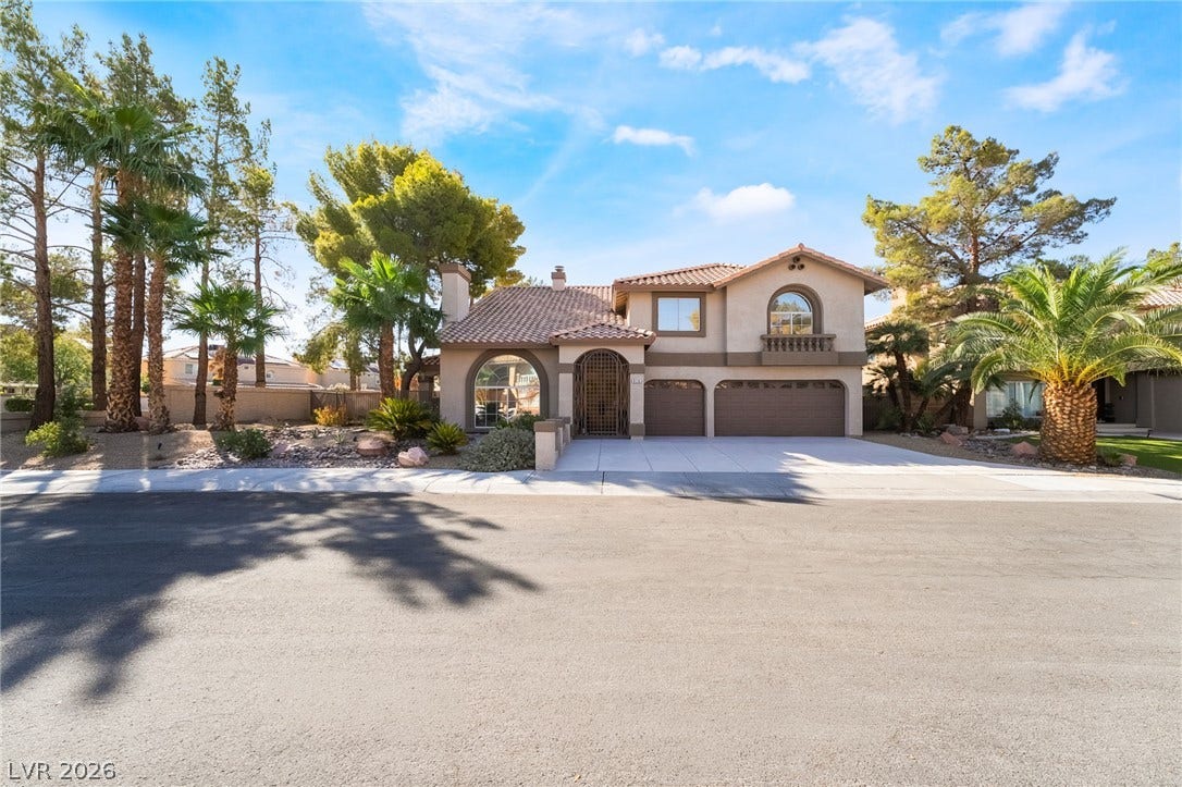 826 Rising Star Drive, Henderson, NV 89014 A classic Spanish tile roof and arched entry define this multi-level facade.