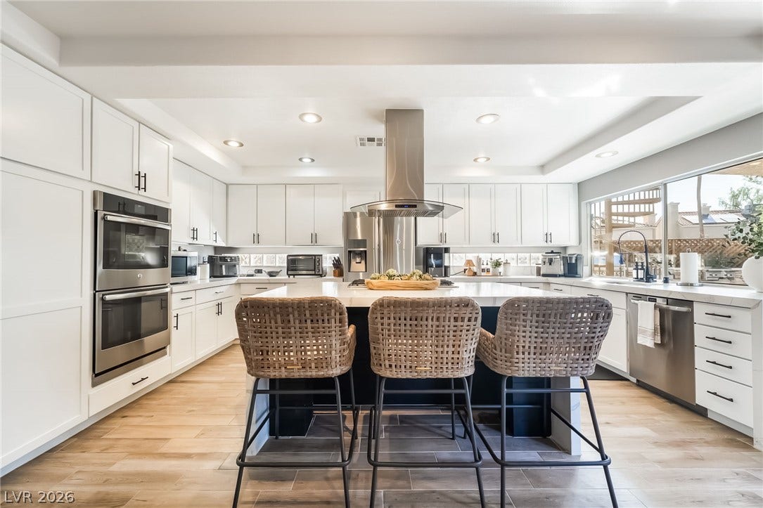 826 Rising Star Drive, Henderson, NV 89014 Recessed lighting illuminates this modern culinary space featuring a large central island and hardwood flooring.