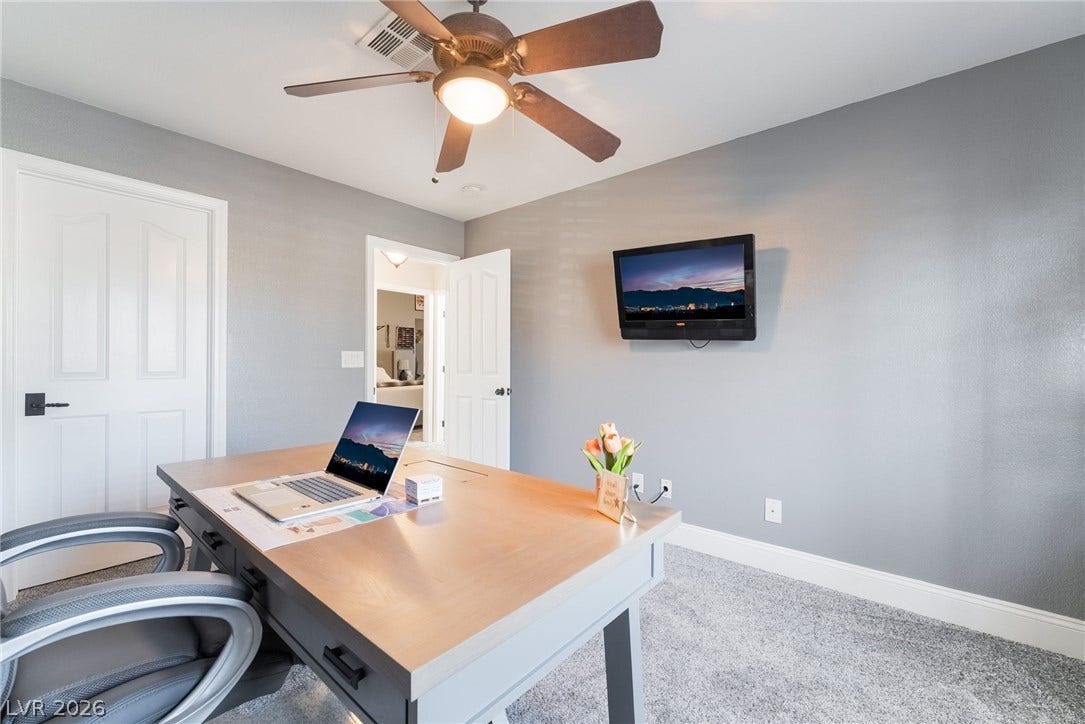 826 Rising Star Drive, Henderson, NV 89014 Smooth walls and plush carpeting anchor this versatile home workspace.
