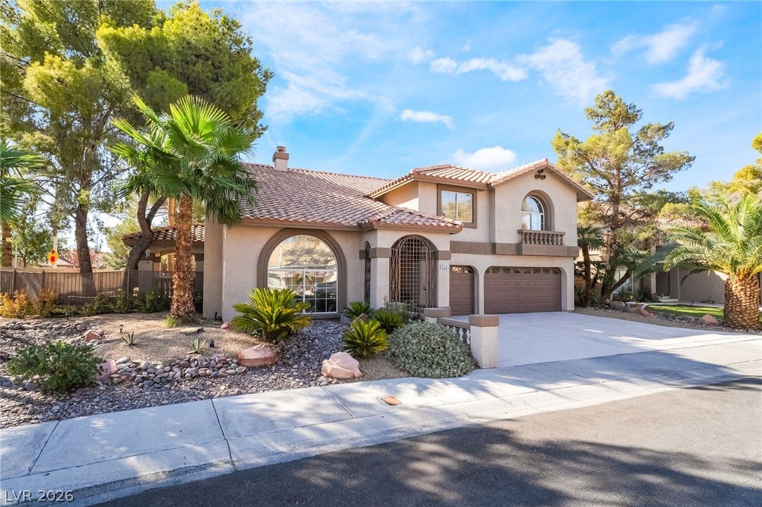 826 Rising Star Drive, Henderson, NV 89014 Mediterranean architectural details and mature desert plantings define this multi-level suburban residence.