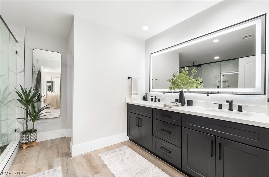 826 Rising Star Drive, Henderson, NV 89014 Clean lines and a floating-style double vanity define this contemporary restroom space.