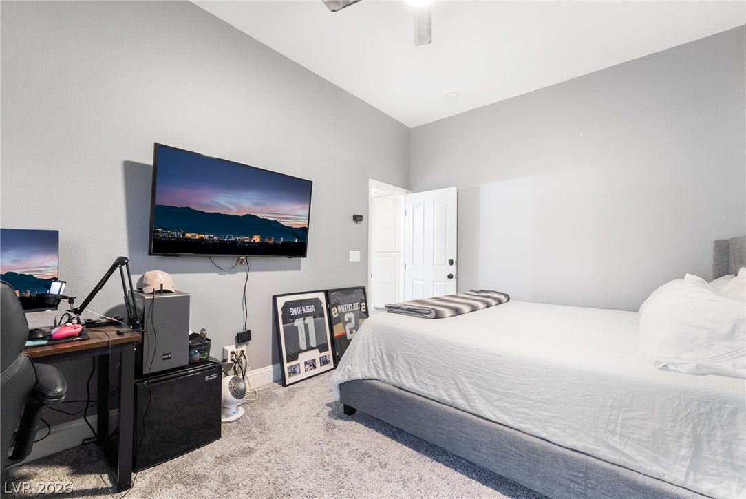 826 Rising Star Drive, Henderson, NV 89014 Smooth plaster walls and soft carpeting define this cozy bedroom with high ceilings.