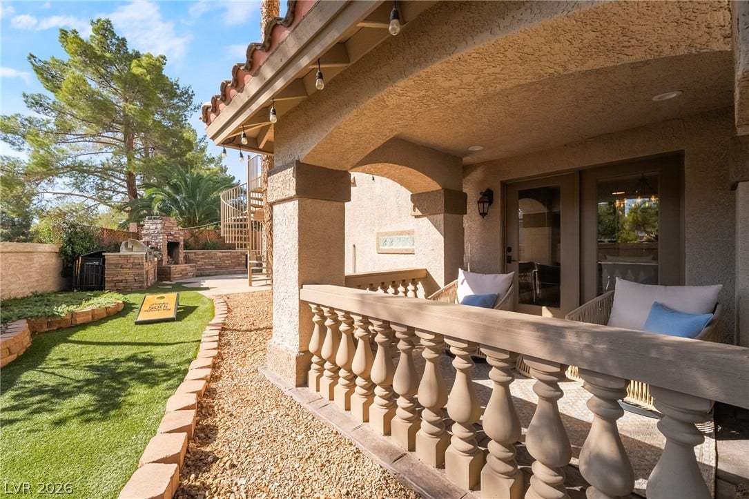 826 Rising Star Drive, Henderson, NV 89014 Arched architectural columns and classic balusters define a sheltered patio overlooking the private backyard.