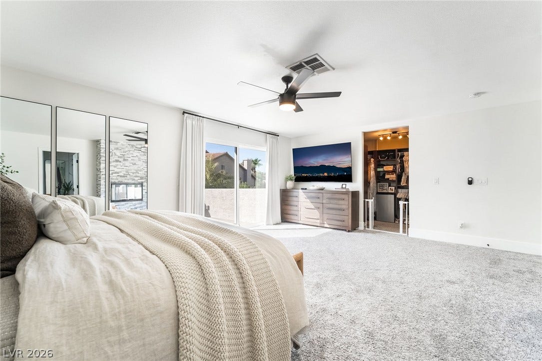 826 Rising Star Drive, Henderson, NV 89014 Sliding glass doors open to outdoor space, highlighting plush carpeting and a walk-in closet.