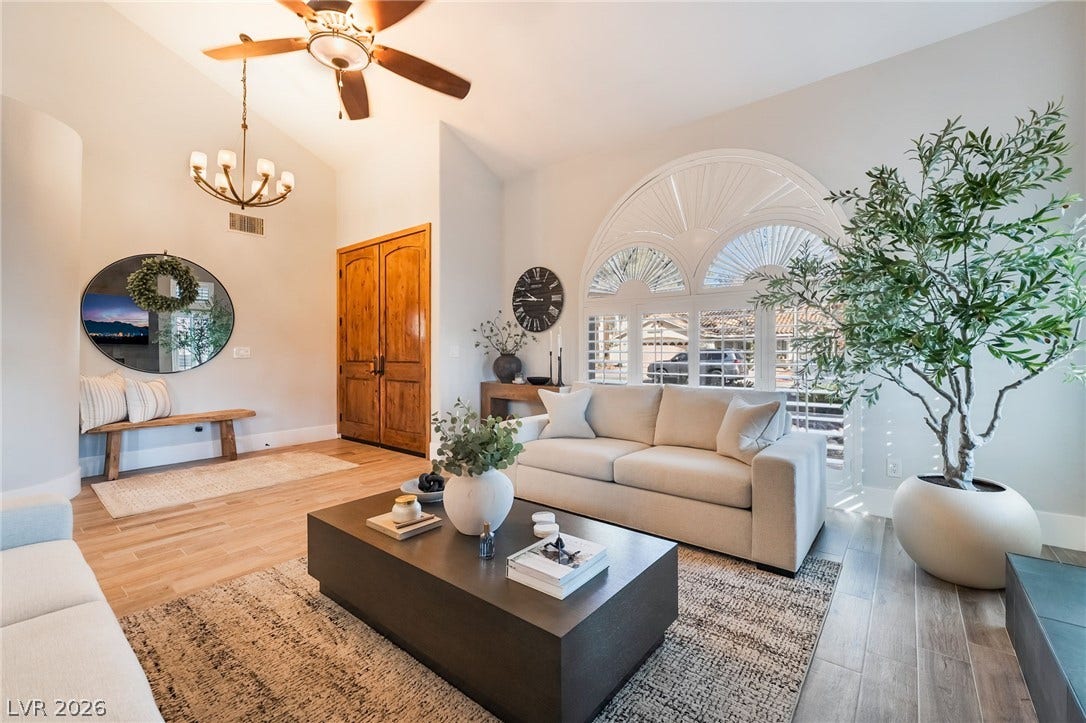 826 Rising Star Drive, Henderson, NV 89014 Arched architectural windows and rich wood flooring anchor this welcoming double-door entryway space.