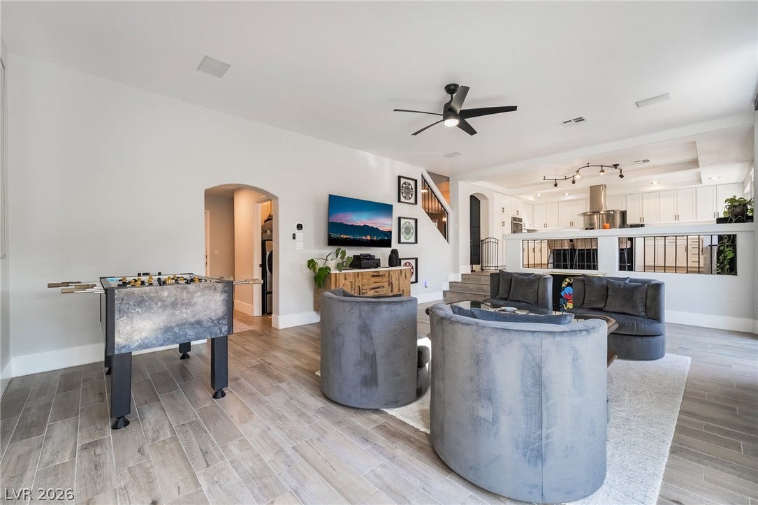826 Rising Star Drive, Henderson, NV 89014 An arched doorway and modern wood-look tile floors define this open-concept main-level living space.