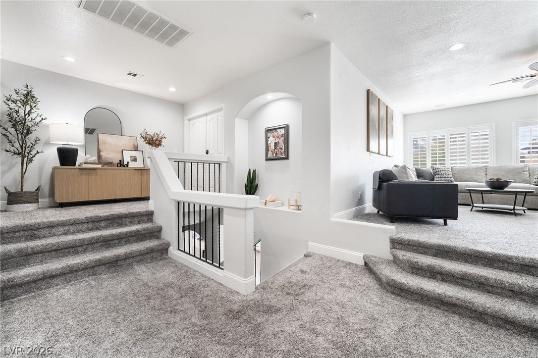 826 Rising Star Drive, Henderson, NV 89014 Multi-level flooring and clean architectural lines define this welcoming entryway and living space.