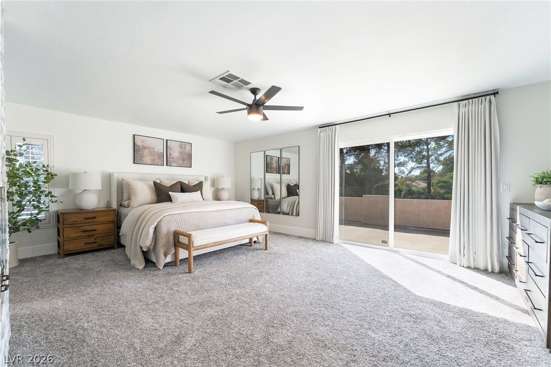 826 Rising Star Drive, Henderson, NV 89014 Sliding glass doors open from this carpeted bedroom to a private outdoor patio space.