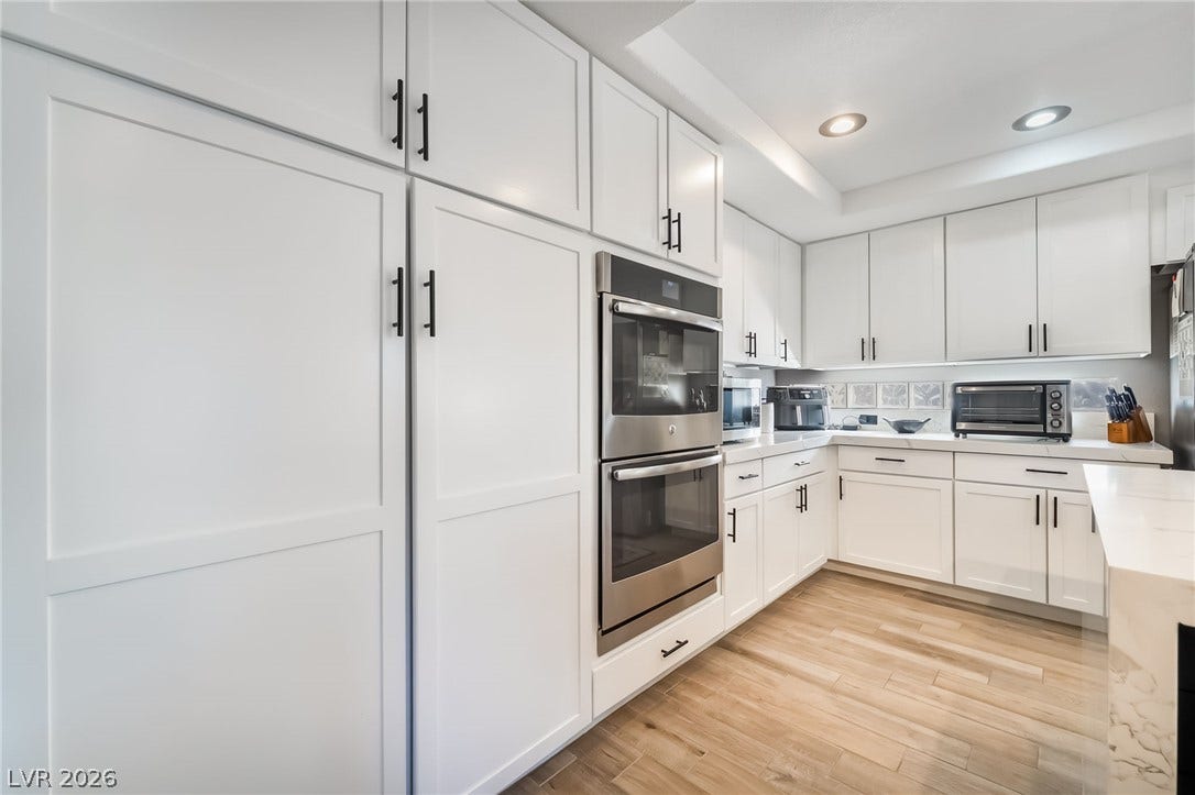 826 Rising Star Drive, Henderson, NV 89014 Streamlined cabinetry and integrated double ovens complement the rich wood-patterned flooring in this gourmet space.