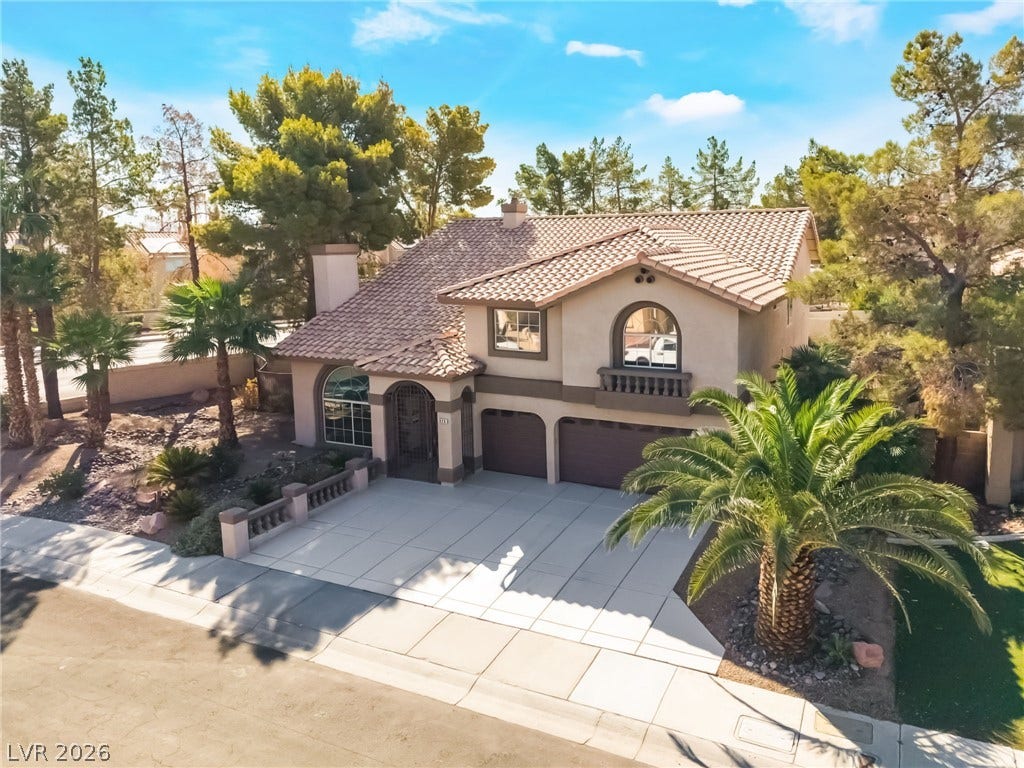 826 Rising Star Drive, Henderson, NV 89014 Spanish tile roofing and custom stucco finishes define this two-story residential exterior.