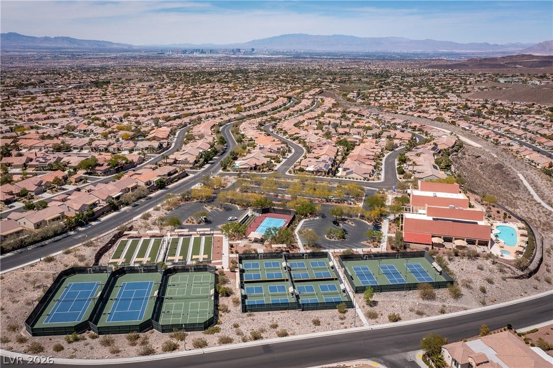2247 Shadow Canyon Drive, Henderson, NV 89044 Aerial view captures extensive neighborhood recreational facilities set against a distant mountain backdrop.