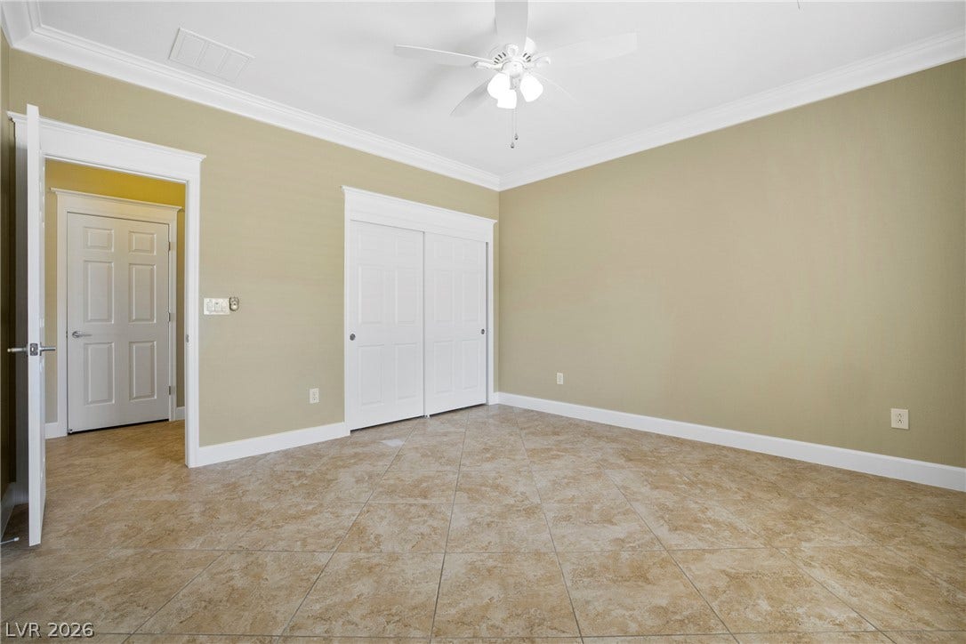 2247 Shadow Canyon Drive, Henderson, NV 89044 Crown molding frames the neutral walls and tile floors of this versatile space.