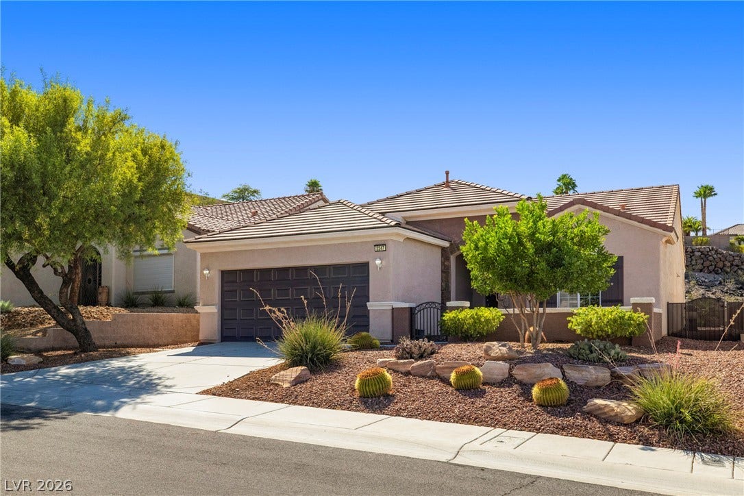 2247 Shadow Canyon Drive, Henderson, NV 89044 Clay tile roofs and desert landscaping define the front exterior of this single-story home.