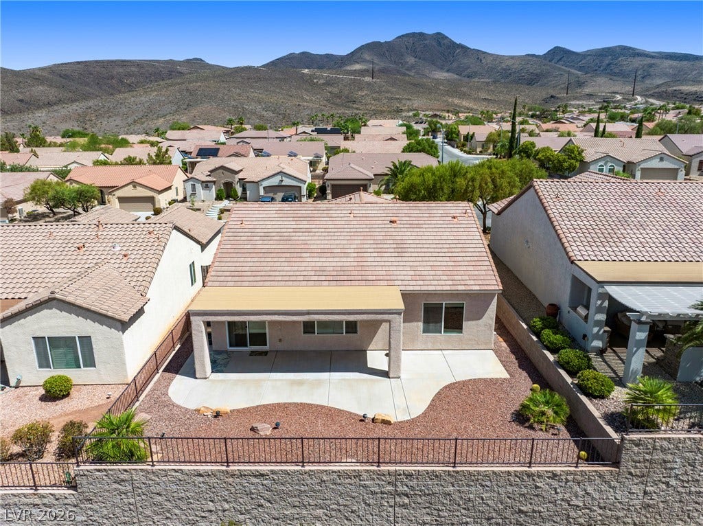 2247 Shadow Canyon Drive, Henderson, NV 89044 Desert mountains rise behind this residential neighborhood featuring tile roofing and fenced backyards.