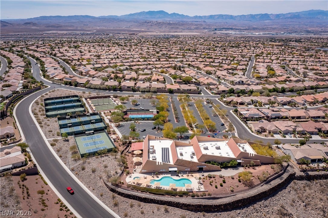 2247 Shadow Canyon Drive, Henderson, NV 89044 An aerial perspective showcases a vibrant community clubhouse with pool and tennis facilities.
