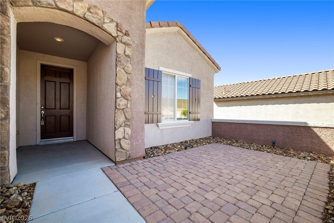 2247 Shadow Canyon Drive, Henderson, NV 89044 An inviting stone-accented entryway leads to a private paver courtyard.