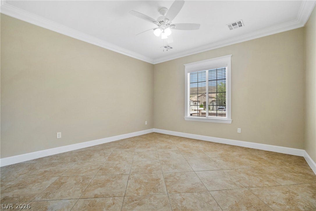 2247 Shadow Canyon Drive, Henderson, NV 89044 Tiled flooring and elegant crown molding define this versatile, windowed room.