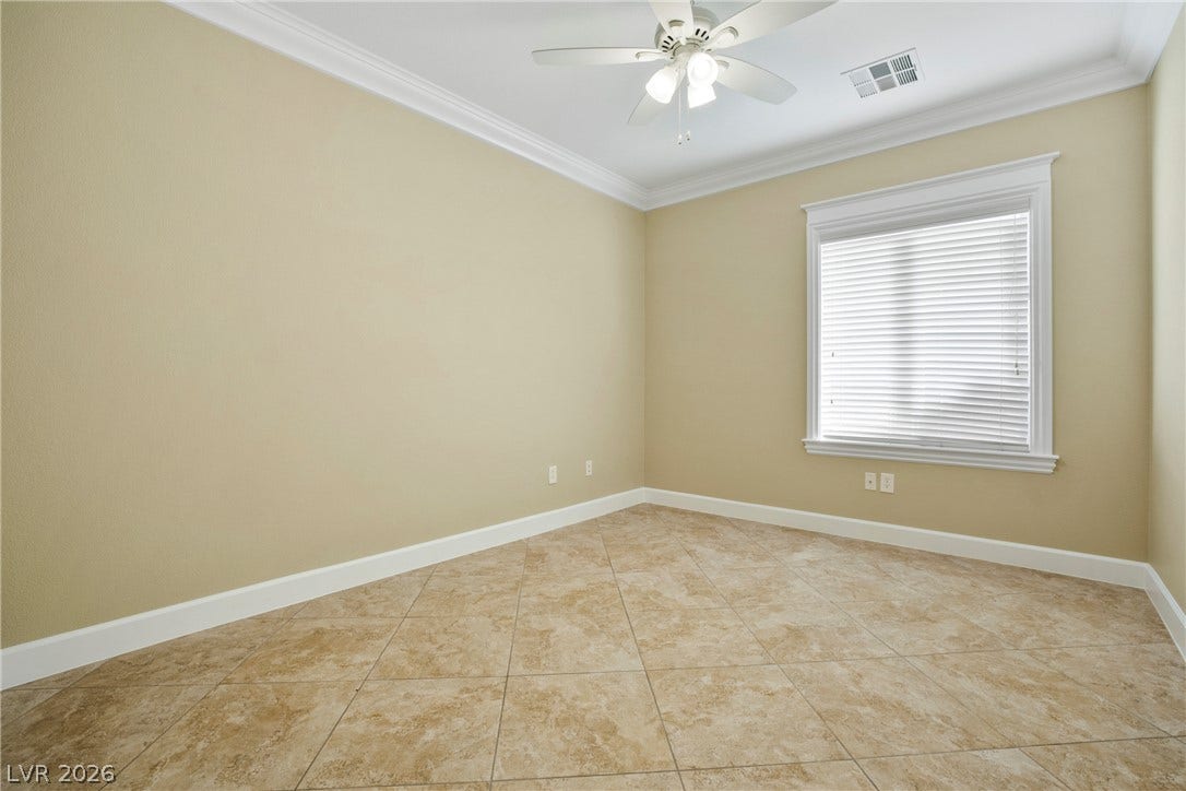 2247 Shadow Canyon Drive, Henderson, NV 89044 Tiled flooring and crown molding highlight this versatile space featuring a classic window.