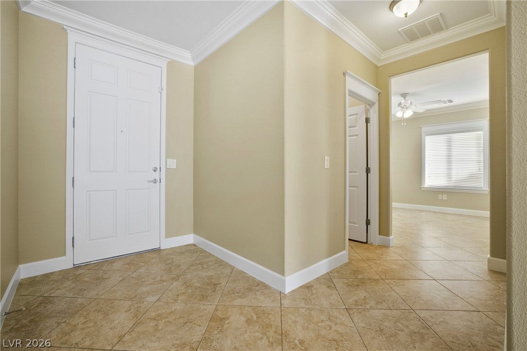 2247 Shadow Canyon Drive, Henderson, NV 89044 Tiled floors and classic crown molding define this welcoming entryway.