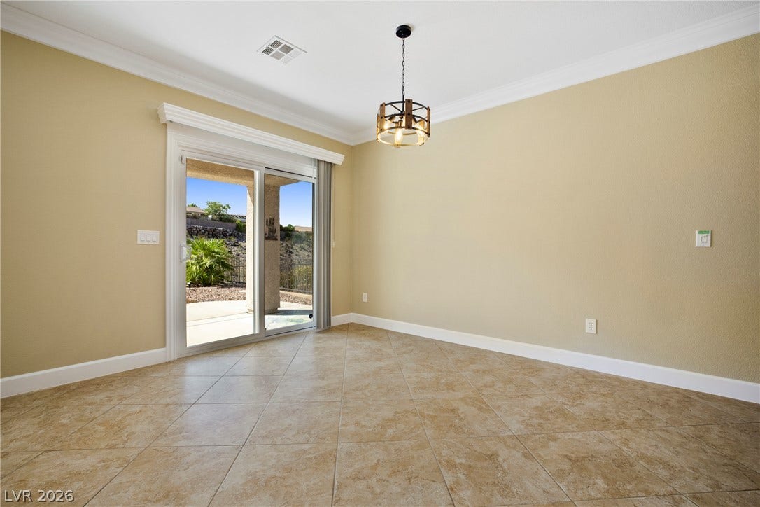 2247 Shadow Canyon Drive, Henderson, NV 89044 Sliding glass doors open to the patio from this dining area with tile flooring.