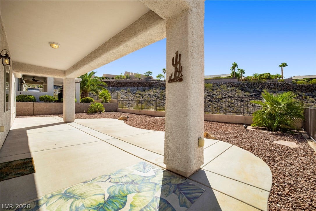 2247 Shadow Canyon Drive, Henderson, NV 89044 A spacious covered concrete patio transitions smoothly into a low-maintenance desert-landscaped yard.