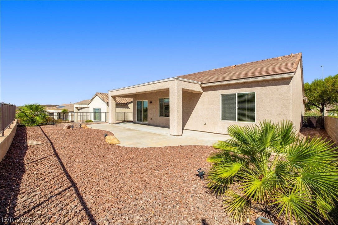 2247 Shadow Canyon Drive, Henderson, NV 89044 A spacious covered patio overlooks the low-maintenance gravel yard under clear blue skies.