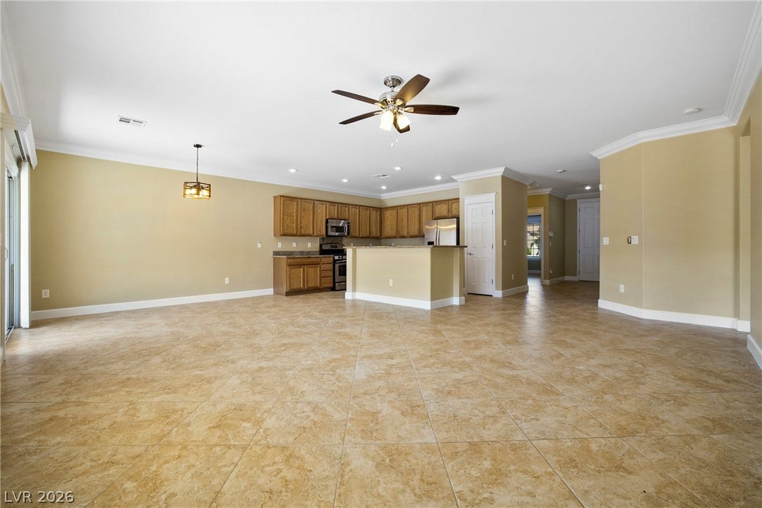2247 Shadow Canyon Drive, Henderson, NV 89044 Tiled flooring and crown molding highlight this open living space connected to the kitchen.