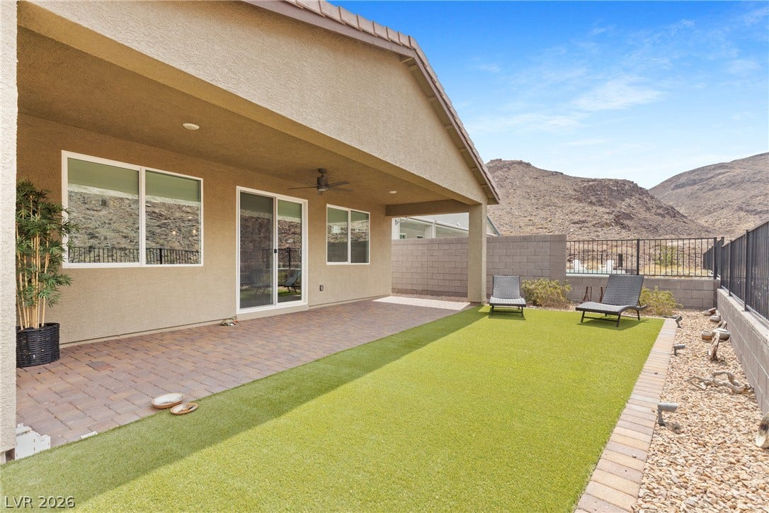 A spacious covered patio opens to a low-maintenance yard framed by scenic mountain views.