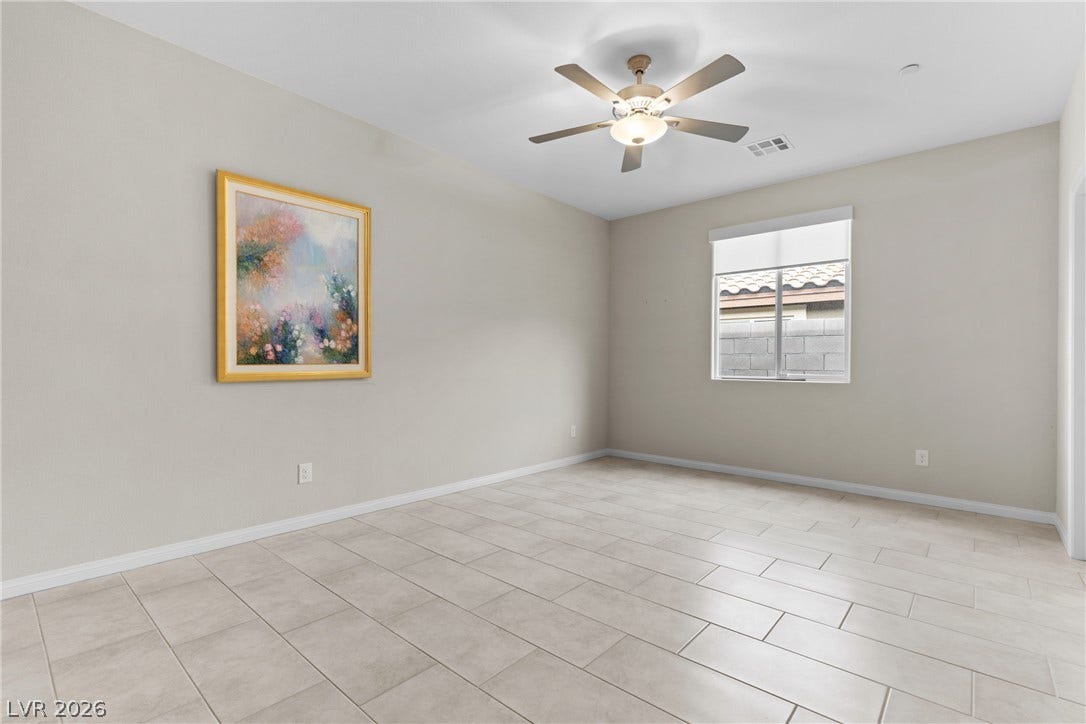 Tiled floors and a large window create a serene atmosphere in this versatile room.
