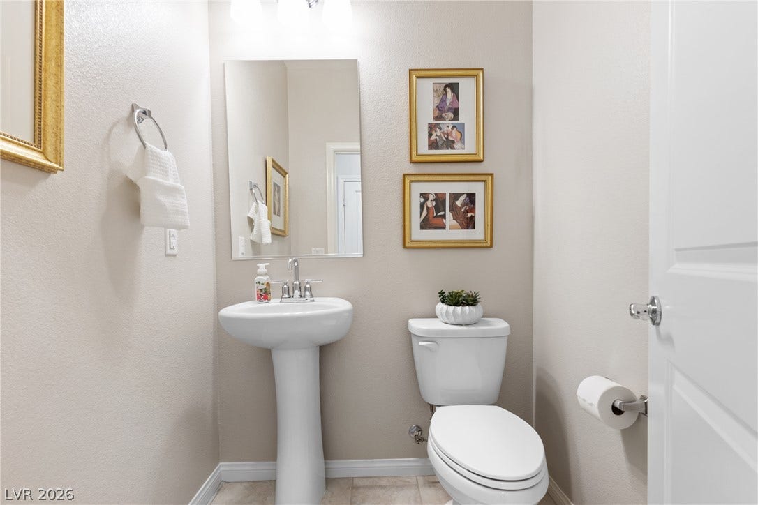 Clean lines and classic fixtures define this half bath with ceramic tile flooring.