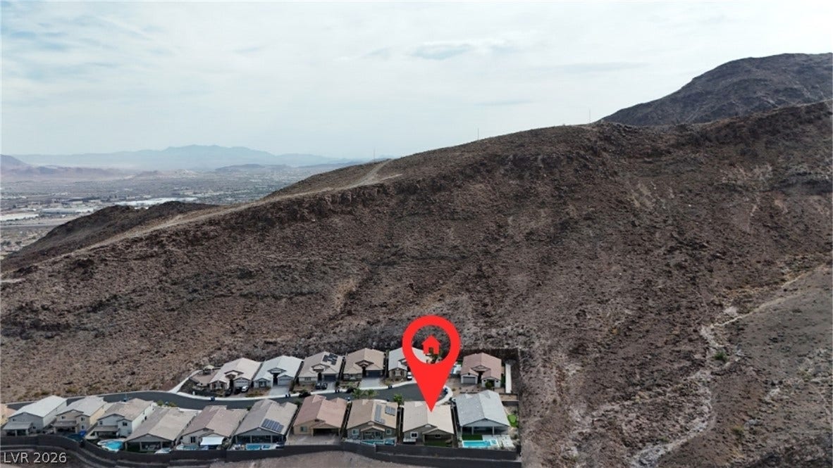 Dramatic mountain ridges frame this elevated residential enclave overlooking the valley floor below.