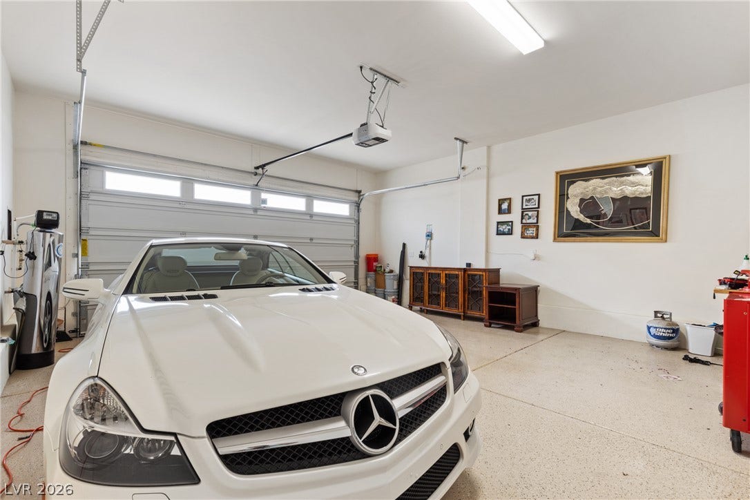 Smooth concrete floors and high ceilings define this clean, spacious garage.