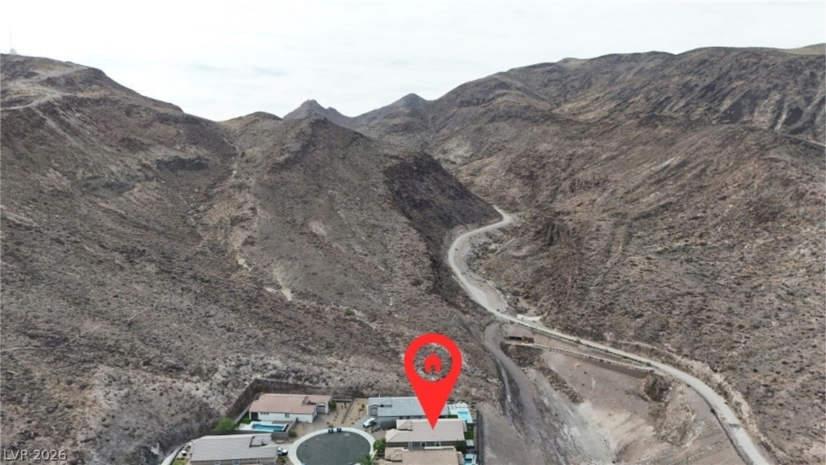 Dramatic mountain ridges frame this desert property nestled against a winding canyon path.