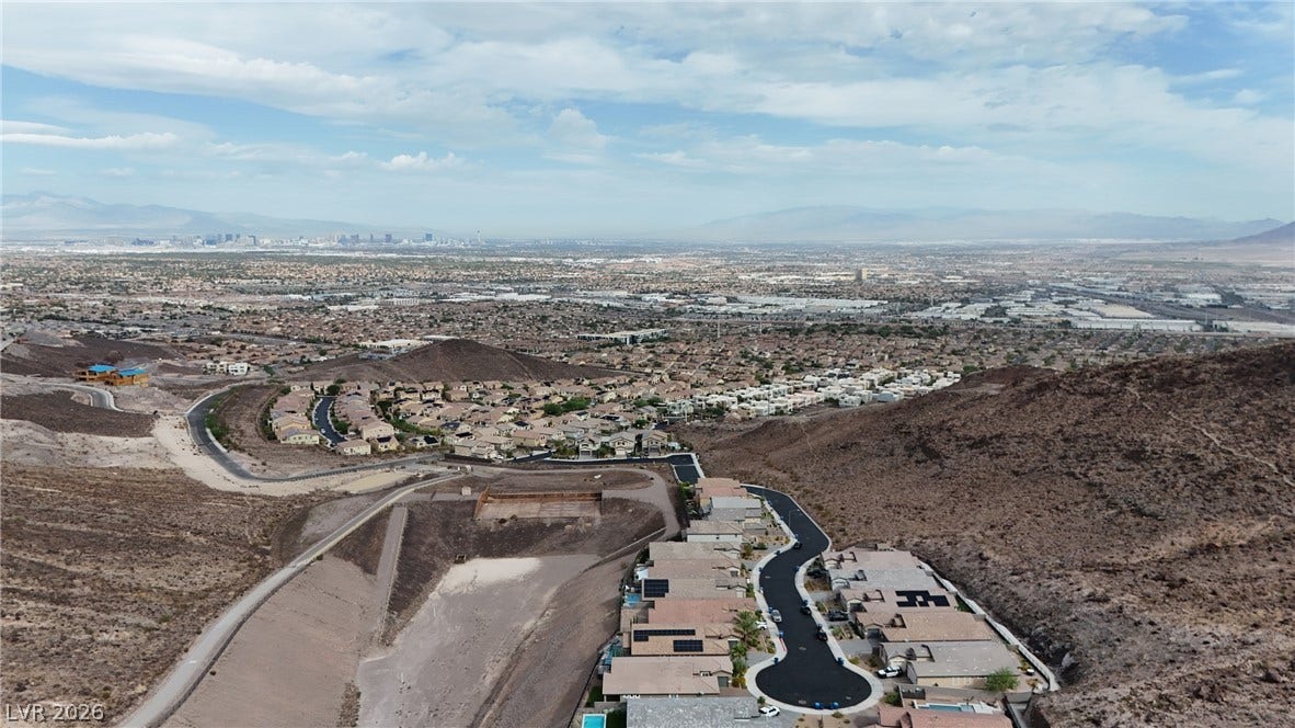 Panoramic mountain and valley vistas stretch across the horizon from this elevated hillside location.