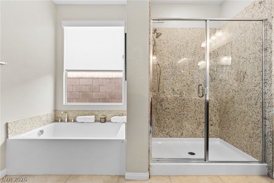 An inviting soaking tub and a glass-enclosed walk-in shower highlight this modern bathroom.