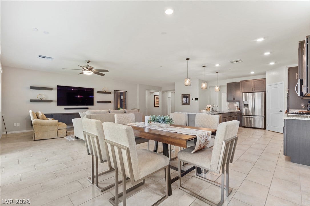 An open floor plan seamlessly connects the tiled dining area to the adjacent kitchen.