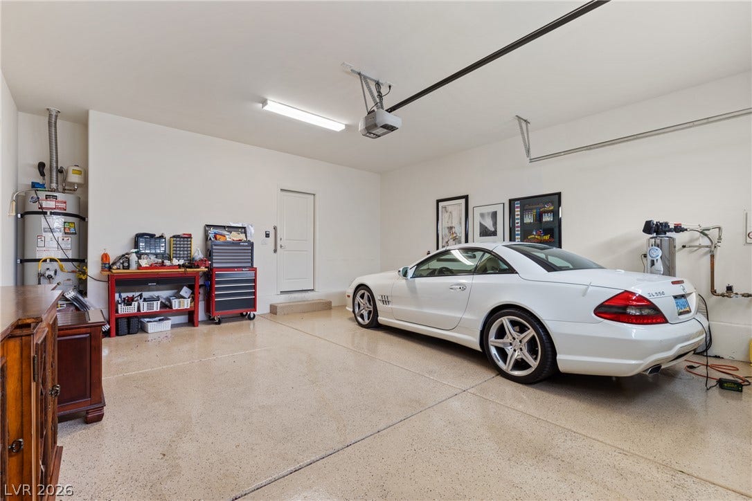 A spacious garage includes epoxy flooring and direct entry to the home.