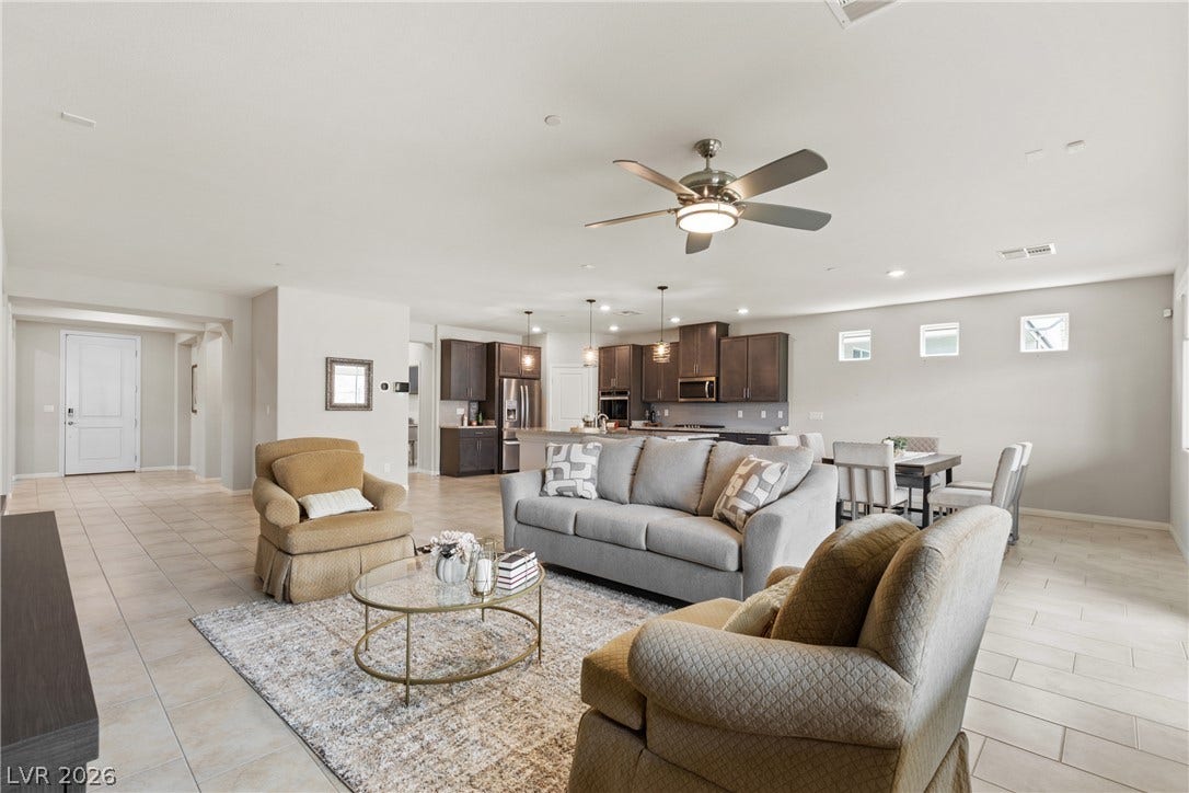 Tiled flooring and a neutral color palette enhance this modern open concept layout.