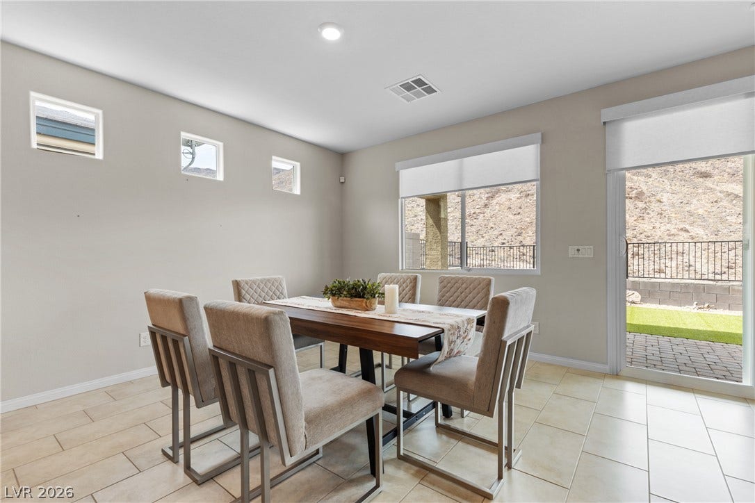 Sliding glass doors open from the dining space directly to the backyard patio.
