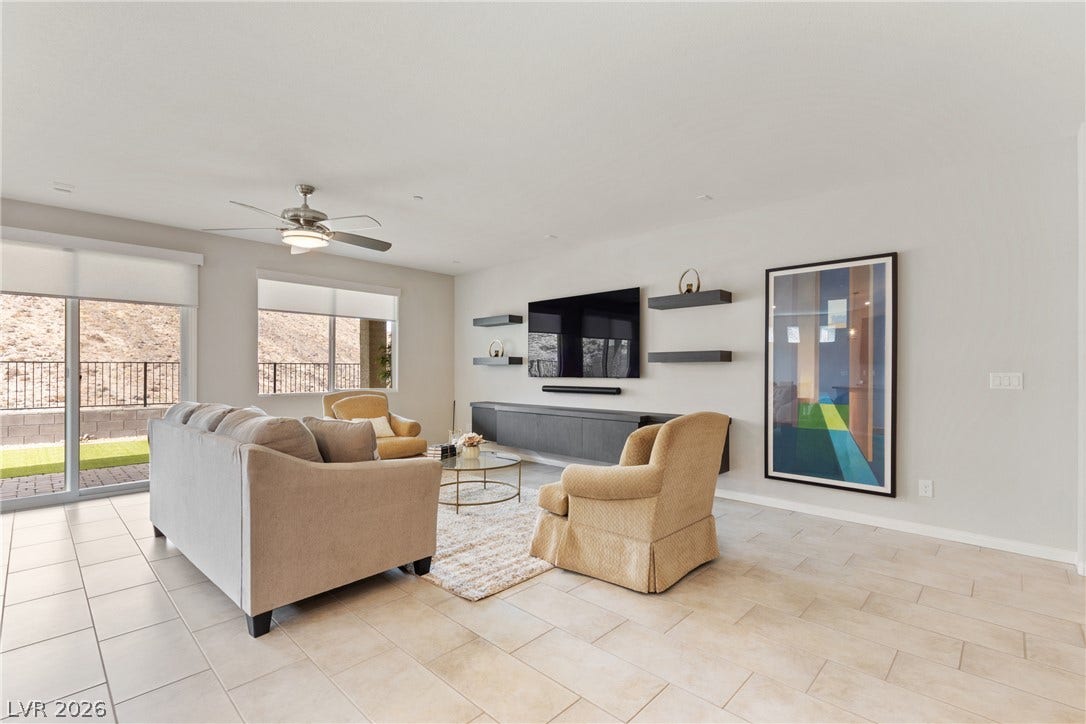 Clean tile flooring and sliding glass doors define this open, contemporary living area.