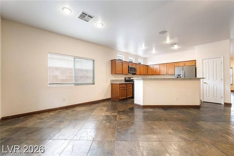 10605 Bardilino Street, Las Vegas, NV 89141 Textured tile flooring runs throughout this open dining area and adjacent kitchen setup.