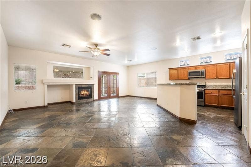 10605 Bardilino Street, Las Vegas, NV 89141 Textured tile floors and a sleek fireplace anchor this airy open-concept layout.