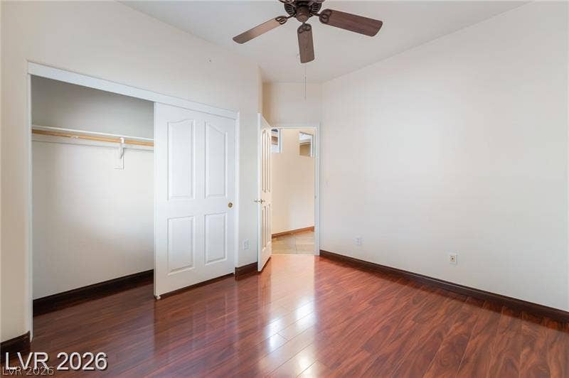 10605 Bardilino Street, Las Vegas, NV 89141 Rich wood flooring anchors this versatile bedroom featuring a spacious closet and clean lines.