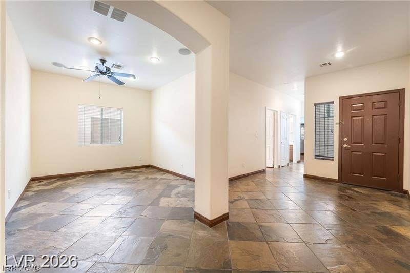 10605 Bardilino Street, Las Vegas, NV 89141 Rich slate tile flooring grounds the welcoming entryway and adjacent versatile living space.