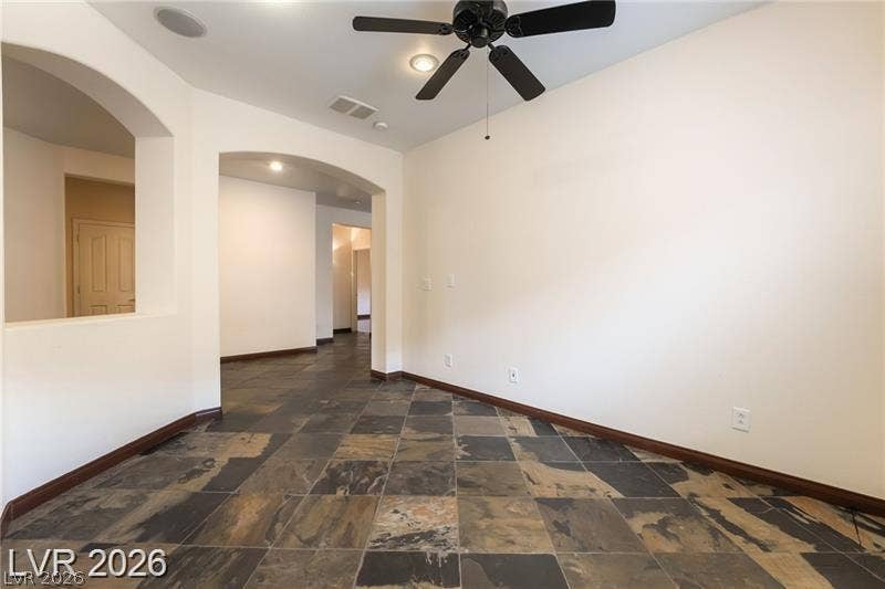 10605 Bardilino Street, Las Vegas, NV 89141 Arched transitions and natural stone tile flooring define this versatile interior space.