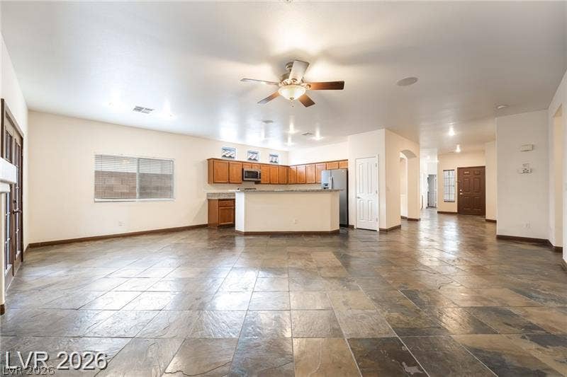 10605 Bardilino Street, Las Vegas, NV 89141 Stone tile floors anchor an open concept living space and kitchen.
