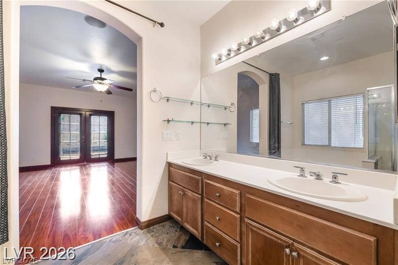 10605 Bardilino Street, Las Vegas, NV 89141 Double vanities and tile flooring define this spacious primary bath opening to the bedroom.